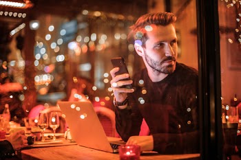 Man Holding Black Smartphone