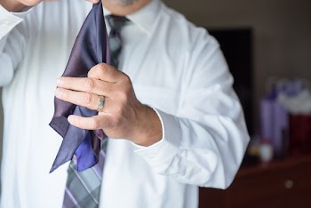 Man Holding Blue Necktie