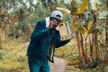 Man Holding Brown Boombox Radio 