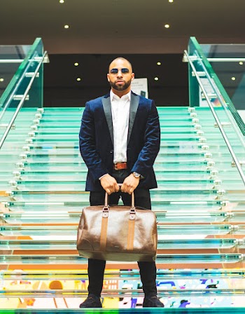 Man Holding Brown Duffel Bag