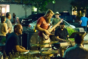Man Holding Brown Electric Guitar