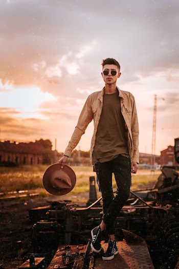 Man Holding Brown Fedora Hat