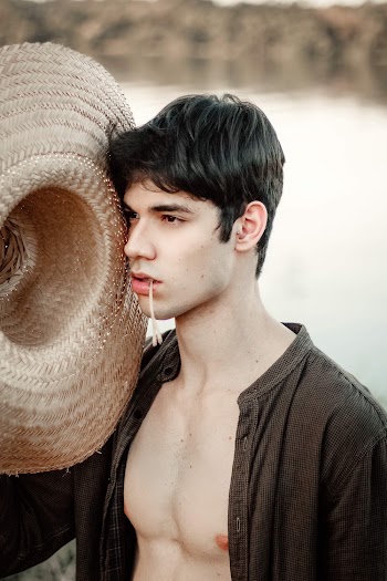 Man Holding Brown Straw Hat