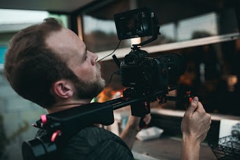 Man Holding Camera in Gimbal Close-up Photography