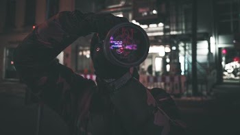 man holding camera standing near building