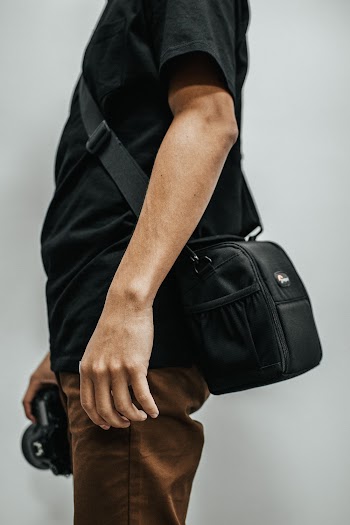 Man Holding Camera While Standing