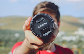 Man Holding Canon Dslr Camera