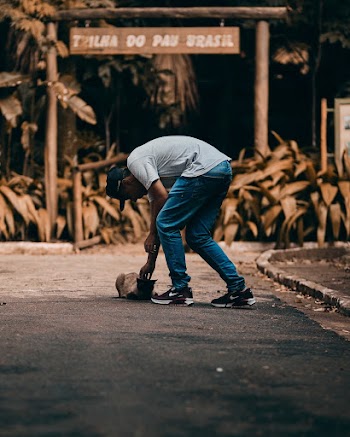 Man Holding Cat at Street