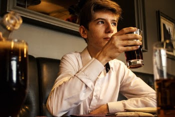 Man Holding Clear Drinking Glass