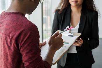 Man Holding Clipboard
