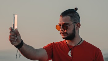 Man Holding Crystal While He Watching It