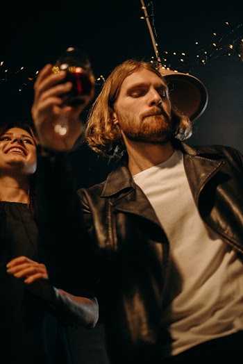 Man Holding Cup Beside Woman