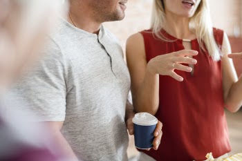 Man Holding Disposable Cup Beside Woman