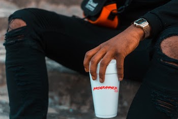 Man Holding Disposable Drinking Cup on Left Hand