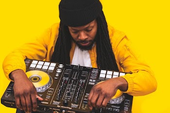 Man Holding Dj Controller on Yellow Background