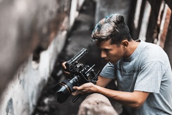 Man Holding Dlsr Camera