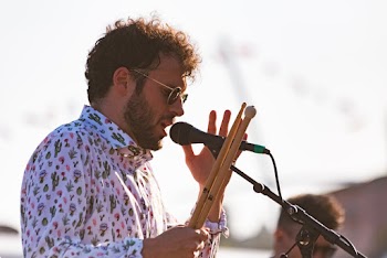 Man Holding Drumstick While Singing 