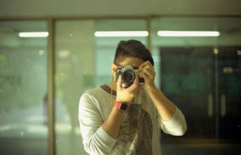man holding DSLR camera