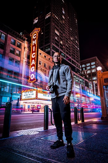 Man Holding Dslr Camera Standing on Street