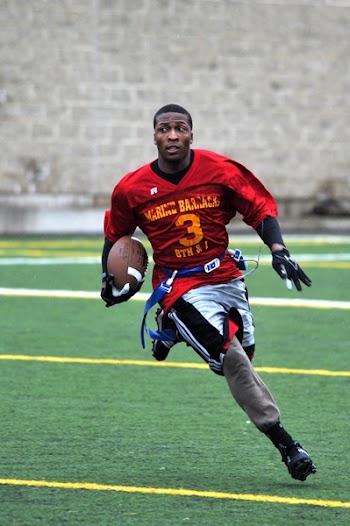 Man Holding Football in Shallow Photo