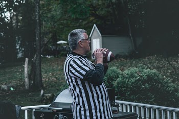 Man Holding Football on Outdoors