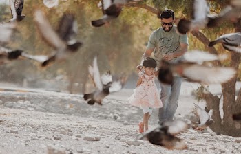 Man Holding Girl