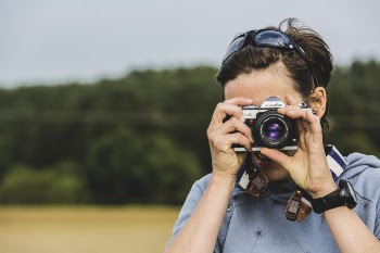 Man Holding Gray and Black Dslr Camera