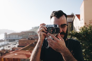 Man Holding Gray Point-and-shoot Camera