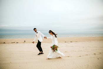 Man Holding Hands With Woman On Seashore