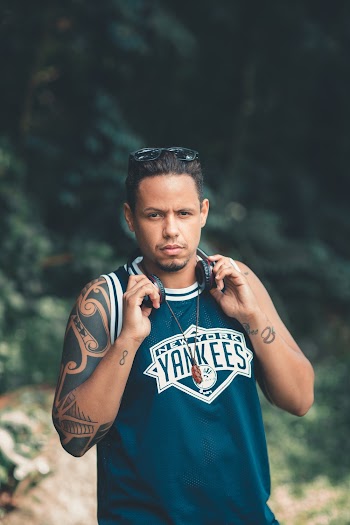 Man Holding Headphones Around Neck