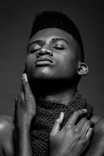 Man Holding His Face and Scarf