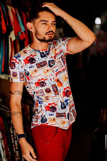Man Holding His Hair Near the Clothes