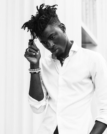 Man Holding His Hair Near Wall