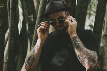 Man Holding His Hippie Sunglasses