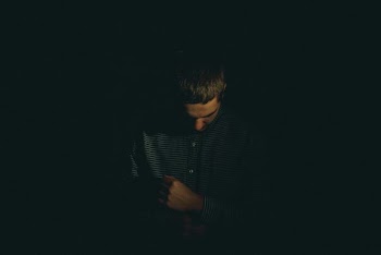 man holding his long-sleeved shirt