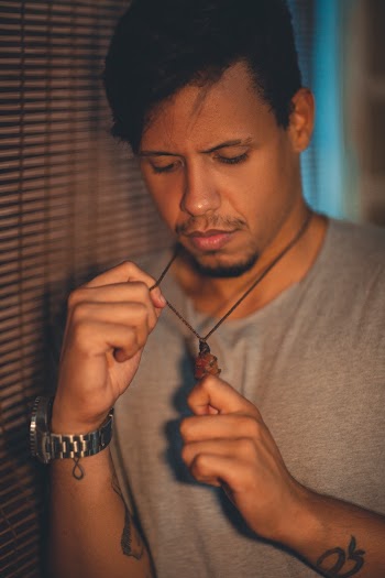 Man Holding His Necklace