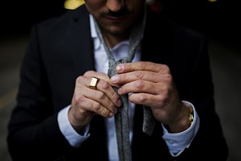 man holding his necktie