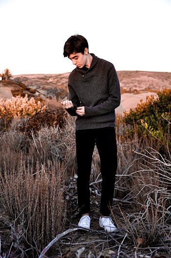 Man Holding His Sleeve Wearing Gray Hoodie