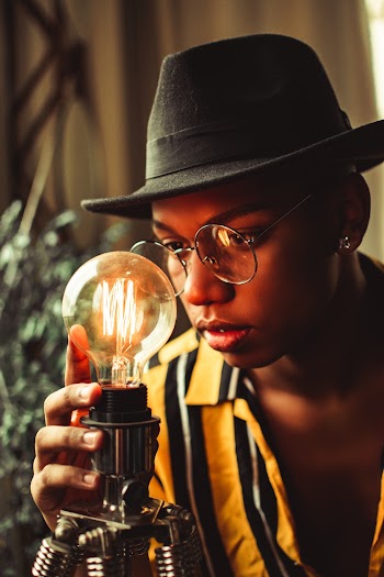Man Holding Lighted Bulb