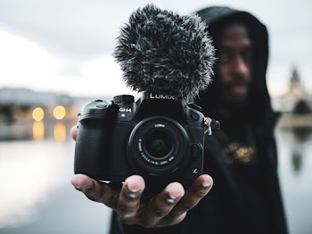 Man Holding Lumix Digital Camera