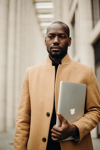 Man Holding Macbook Pro