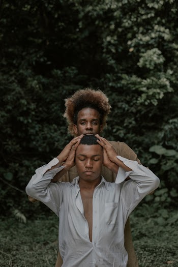 Man Holding Man's Head 