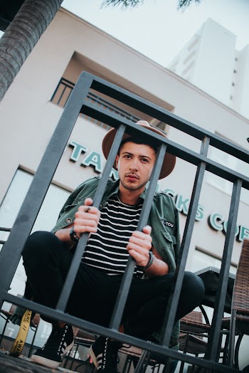 Man Holding Metal Railings