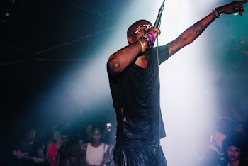 Man Holding Mic Performing on Stage