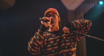 Man Holding Microphone in Shallow Photo