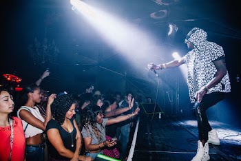 Man Holding Microphone Performing at Stage