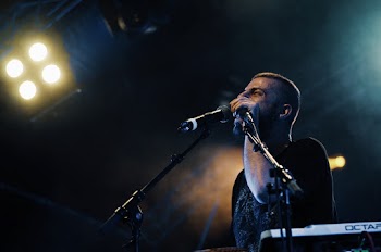 Man Holding Microphone Performing on Stage