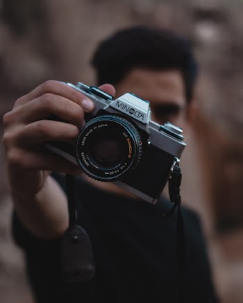 Man Holding Minolta Camera