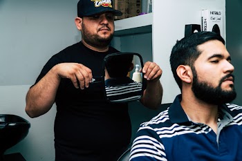 Man Holding Mirror Behind Man