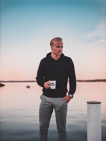 Man Holding Mug While Standing On Dock
